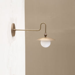 One-Light Brass Dish Wall Sconce with Curved Arm and Milk Glass Shade
