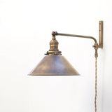 One-Light Plug-In Swing Arm Wall Sconce with Brass Cone Shade